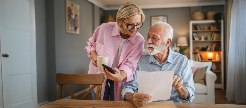 A couple receiving and reading their election direct mail.