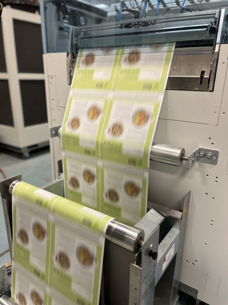 A direct mail print job printing on a roll-fed digital printer.
